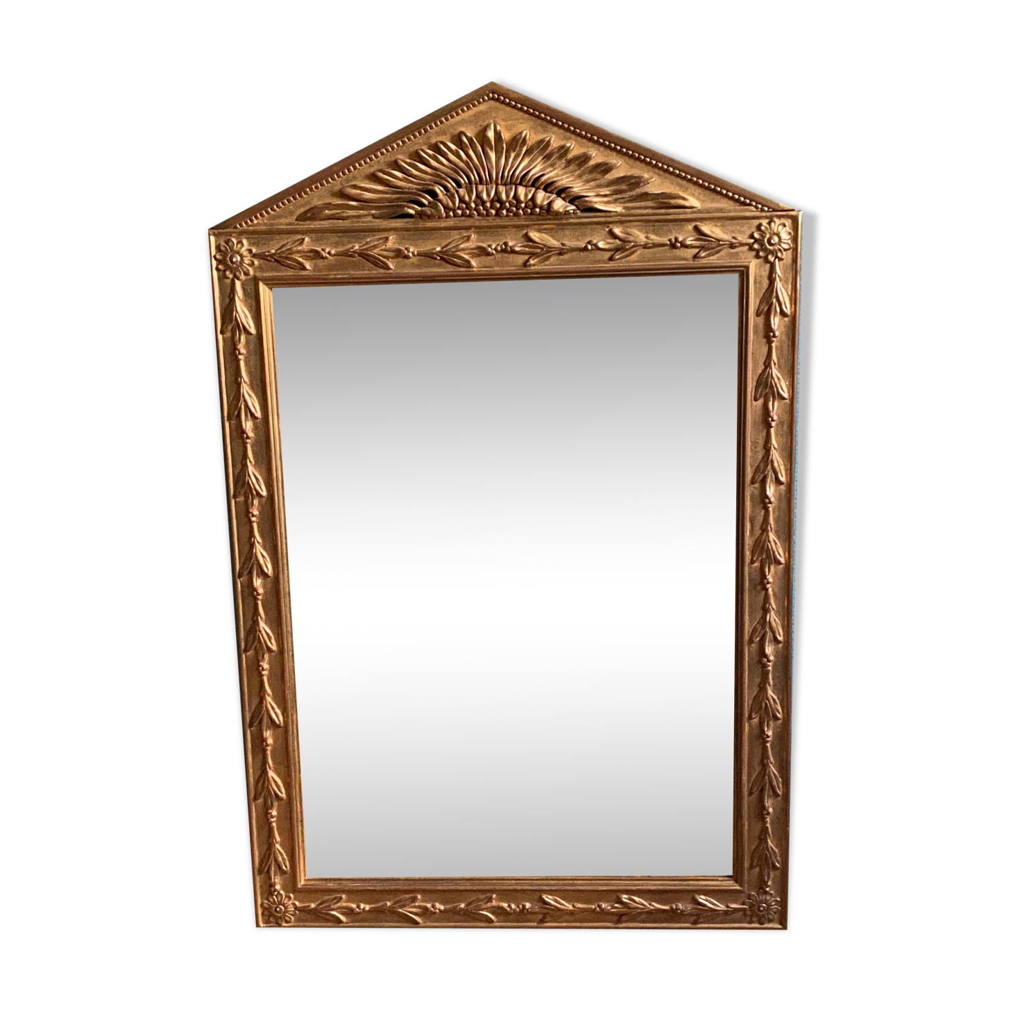 Mirror in gilded wood with a triangle pediment decorated with half sunflowers