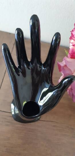 Hand holds black jewelry, ring sizer, soliflore, vintage French, 50s