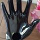 Hand holds black jewelry, ring sizer, soliflore, vintage French, 50s