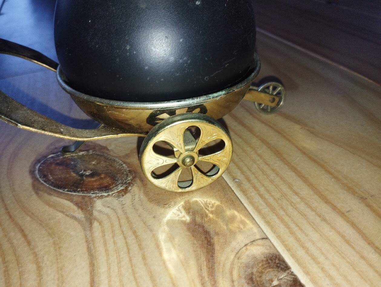 Original vintage ashtray on a small wheeled stand.