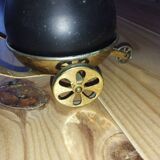 Original vintage ashtray on a small wheeled stand.