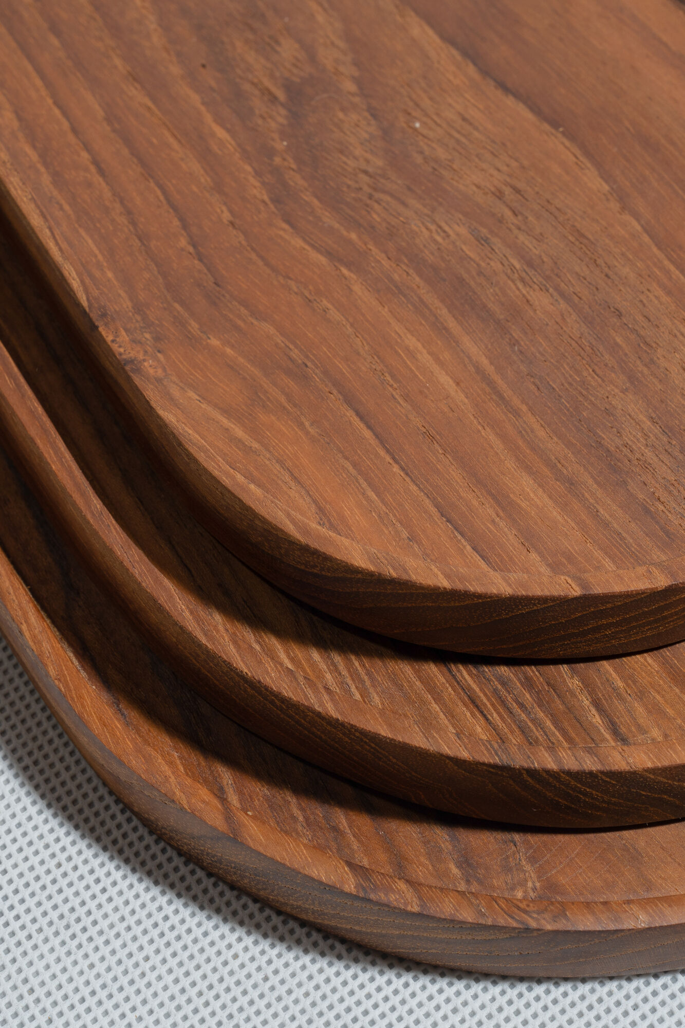 Trio of oval teak trays or cups