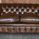 Restored leather Chesterfield sofa, walnut legs.