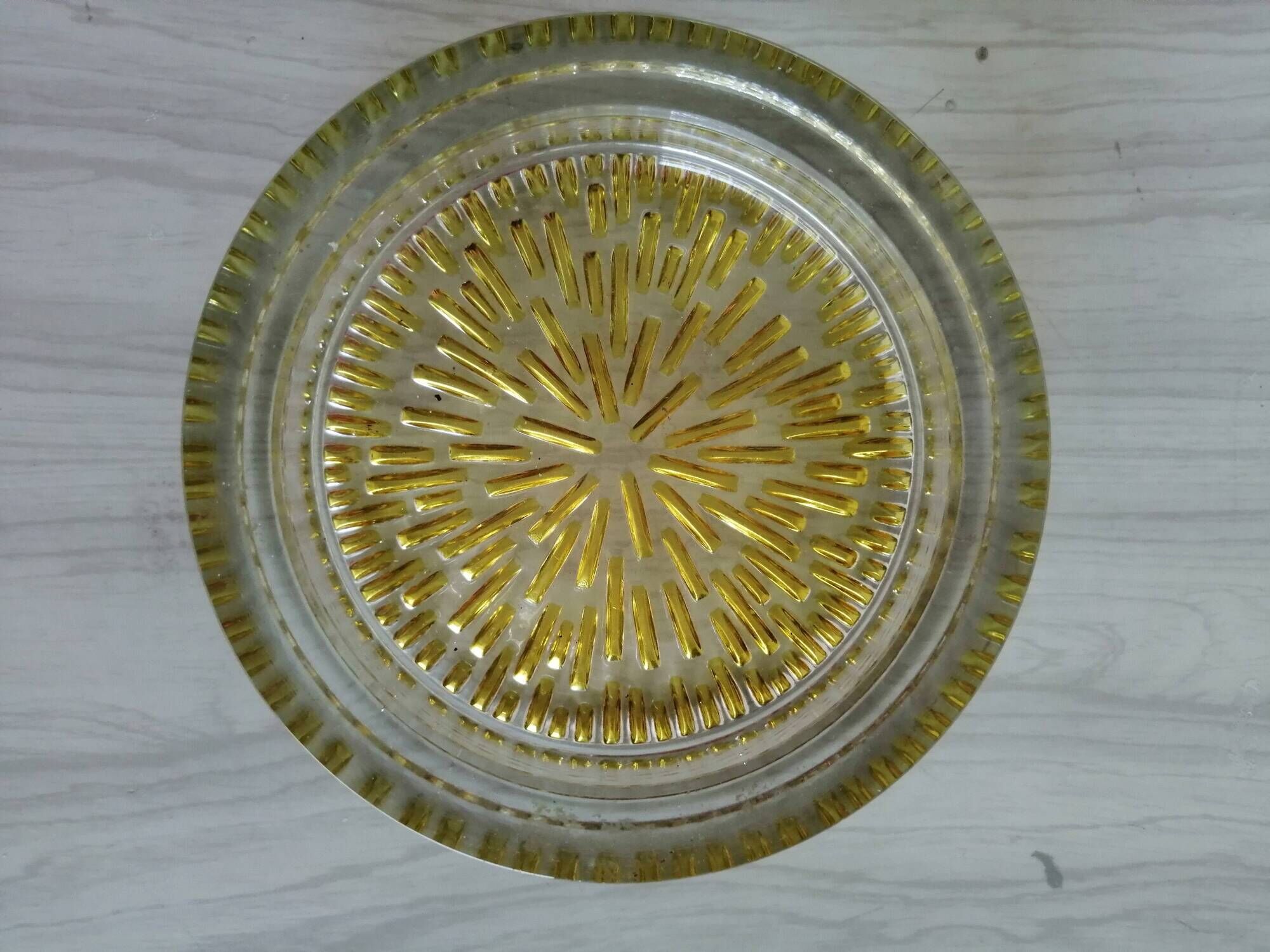 Empty round pockets of iridescent transparent glass of yellow sticks