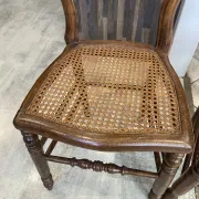 Pair of antique caned and wooden chairs from the 1900s.