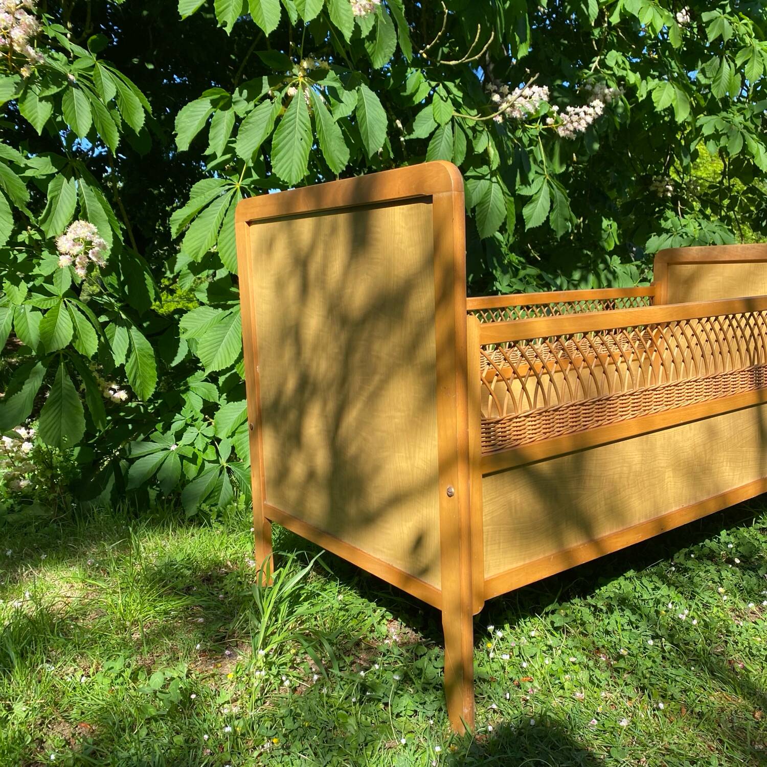 Vintage wooden and rattan baby cot from the 1960s.