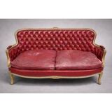 Louis XV style basket canapé with a curved back, upholstered in leather.