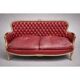 Louis XV style basket canapé with a curved back, upholstered in leather.