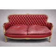 Louis XV style basket canapé with a curved back, upholstered in leather.