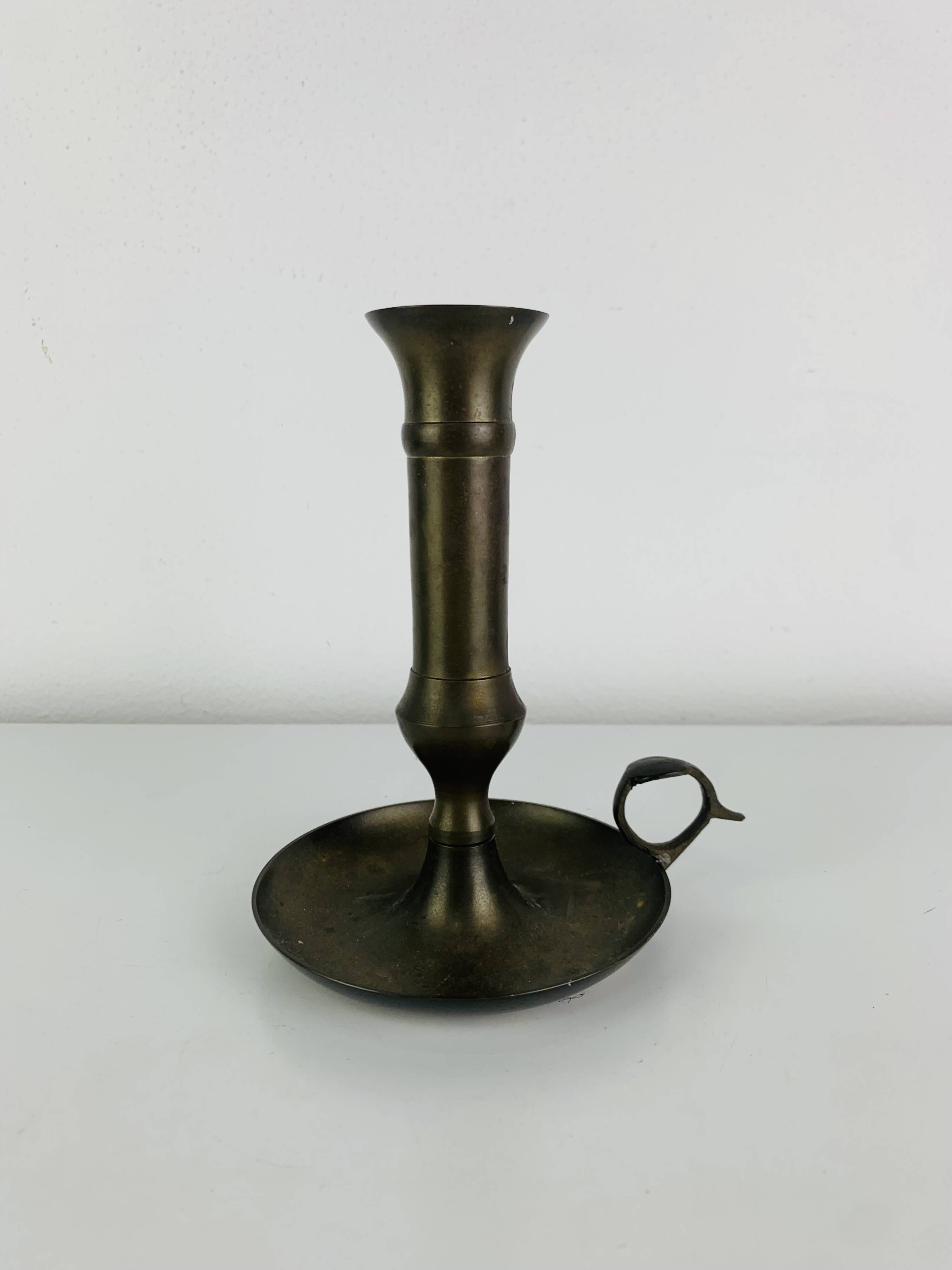 Vintage brass candlestick that raises and lowers.