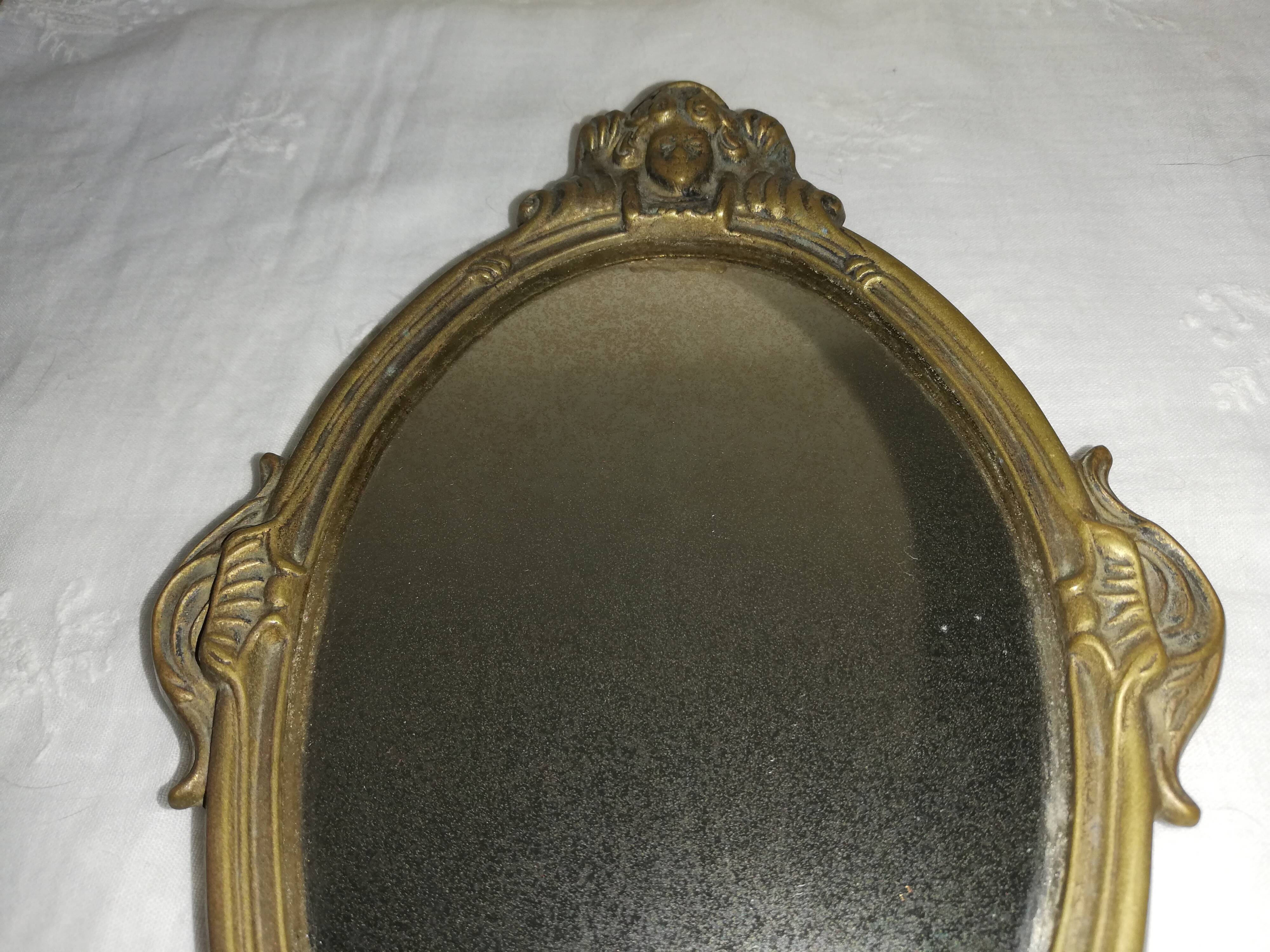 Old hand-facing mirror in gilded bronze