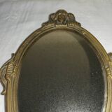 Old hand-facing mirror in gilded bronze