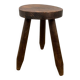 Small brutalist tripod stool in solid wood.