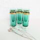 Set of 6 green champagne flutes with a golden rim.