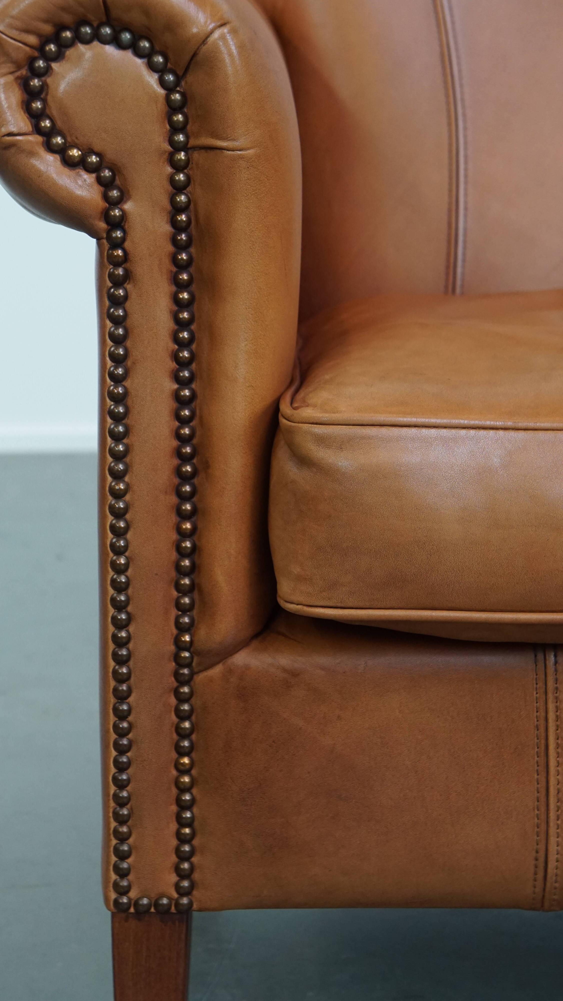 Cognac-colored cowhide leather armchair