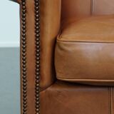 Cognac-colored cowhide leather armchair
