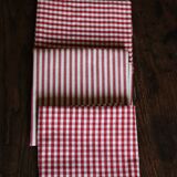 A set of 4 red striped and checkered napkins.
