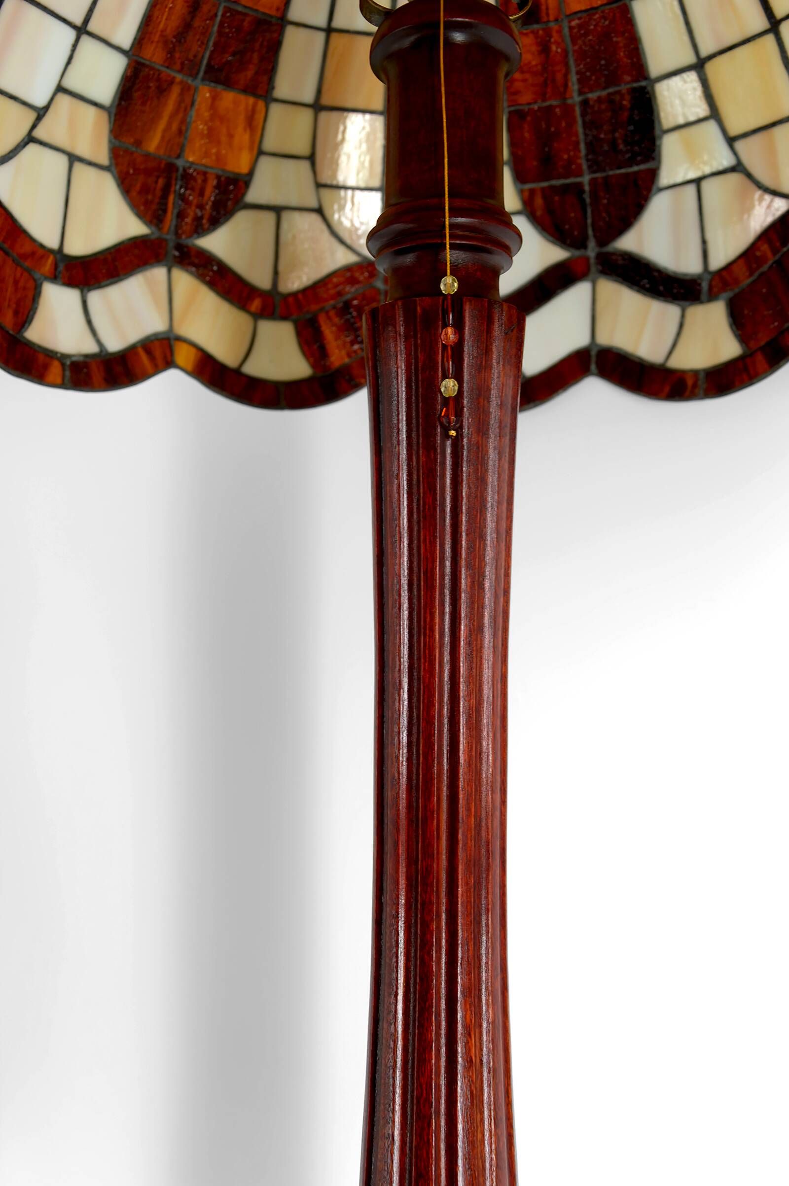 Art Deco floor lamp in carved walnut, stained glass shade, France, c. 1920