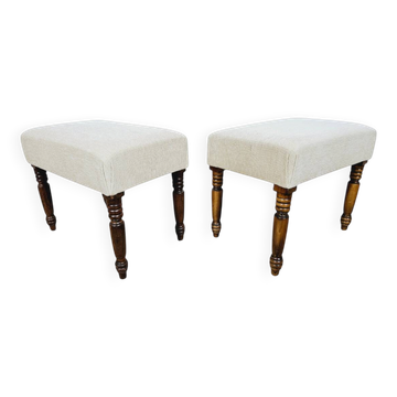 A pair of English upholstered pouffes/footstools from the 19th century