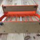 Space age wall coat rack, orange wood, with its shelf from the 1970s.