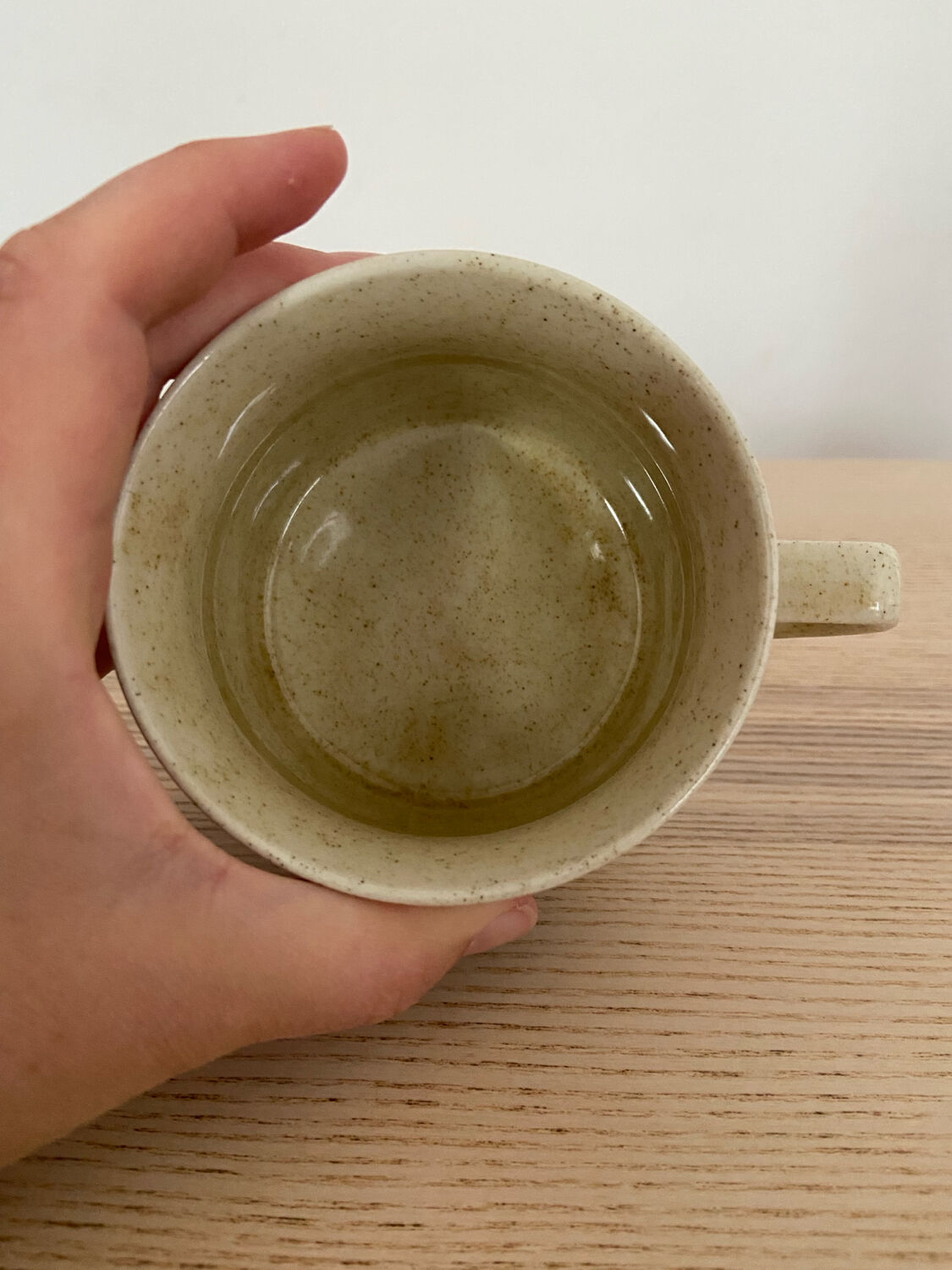 Speckled stoneware cup with blue flower