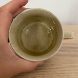 Speckled stoneware cup with blue flower