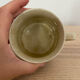 Speckled stoneware cup with blue flower