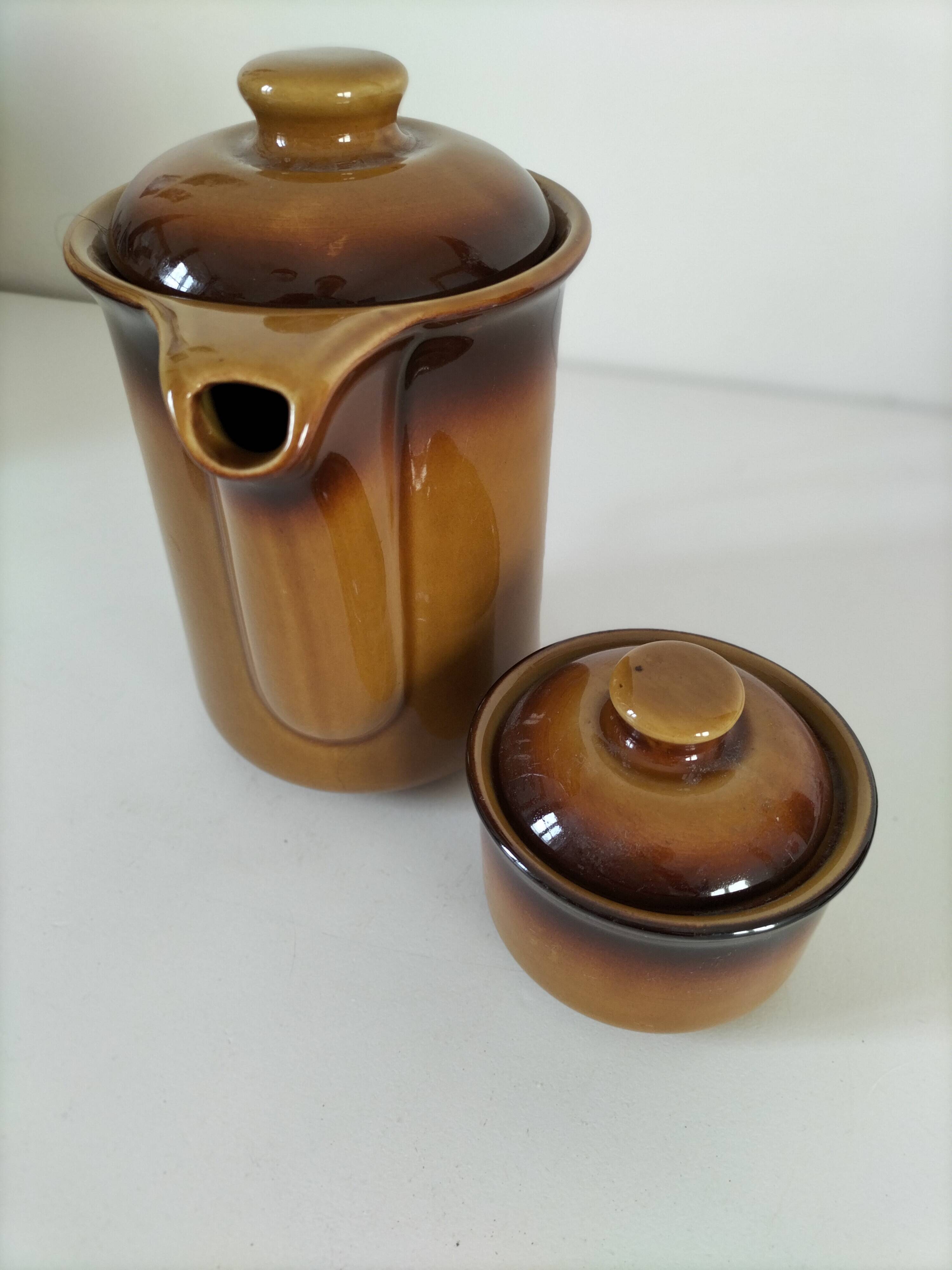 Coffee pot and sugar bowl in glazed stoneware, deep brown glazes.