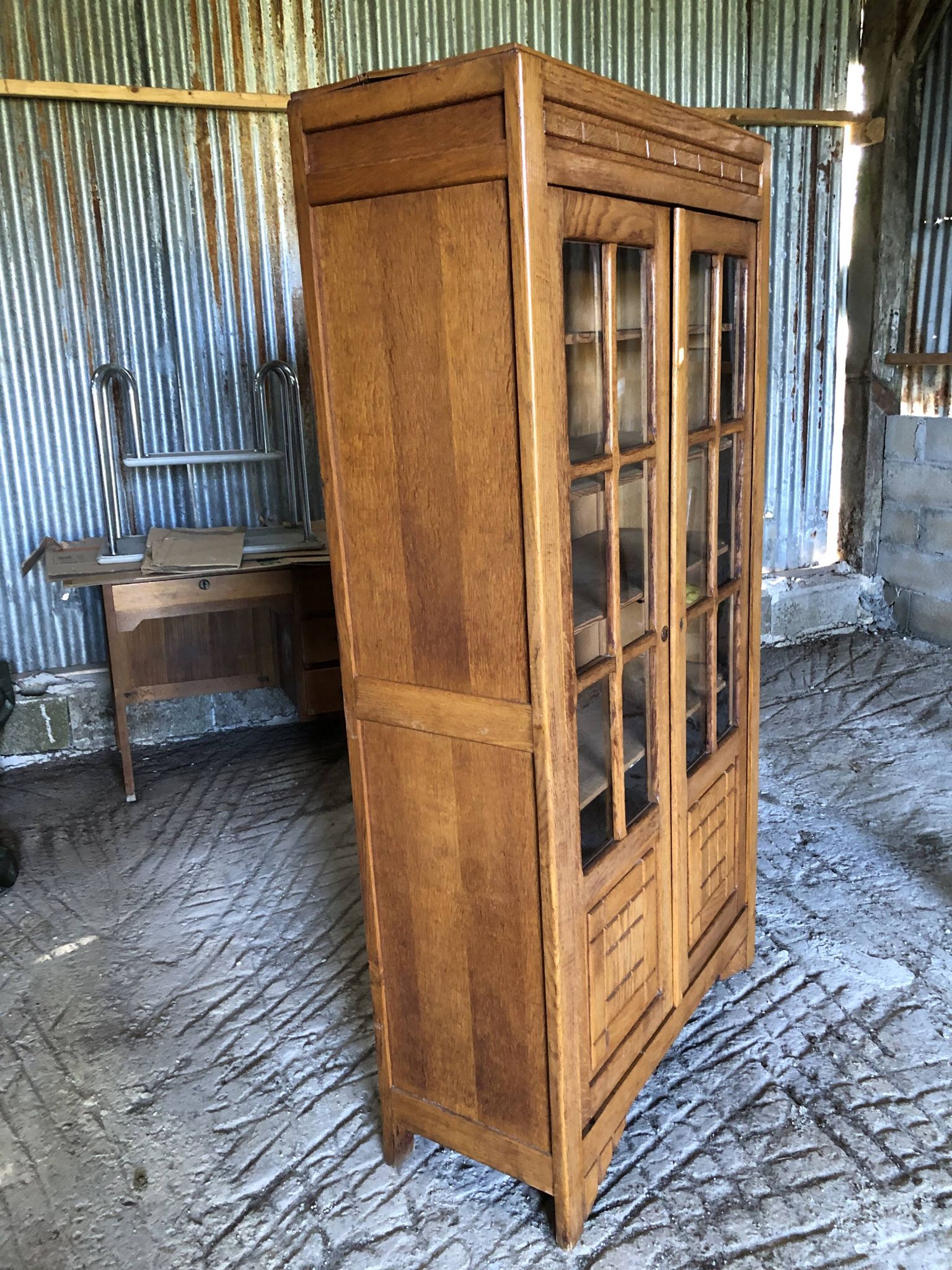 Vintage oak bookcase from the reconstruction period with 2 doors with small panes.