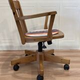 Solid wood swivel and reclining armchair.