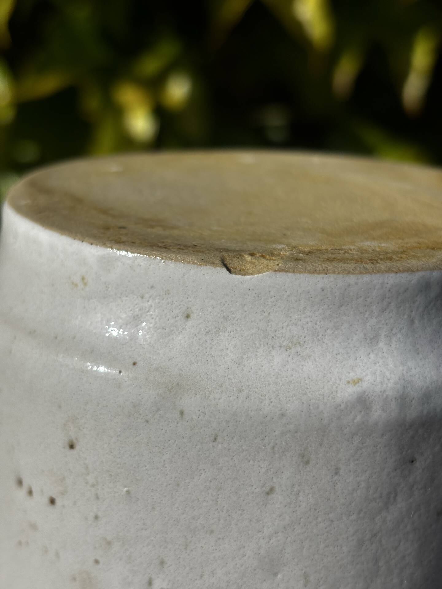 Pretty pot or vase in glazed stoneware with blue drip effect.