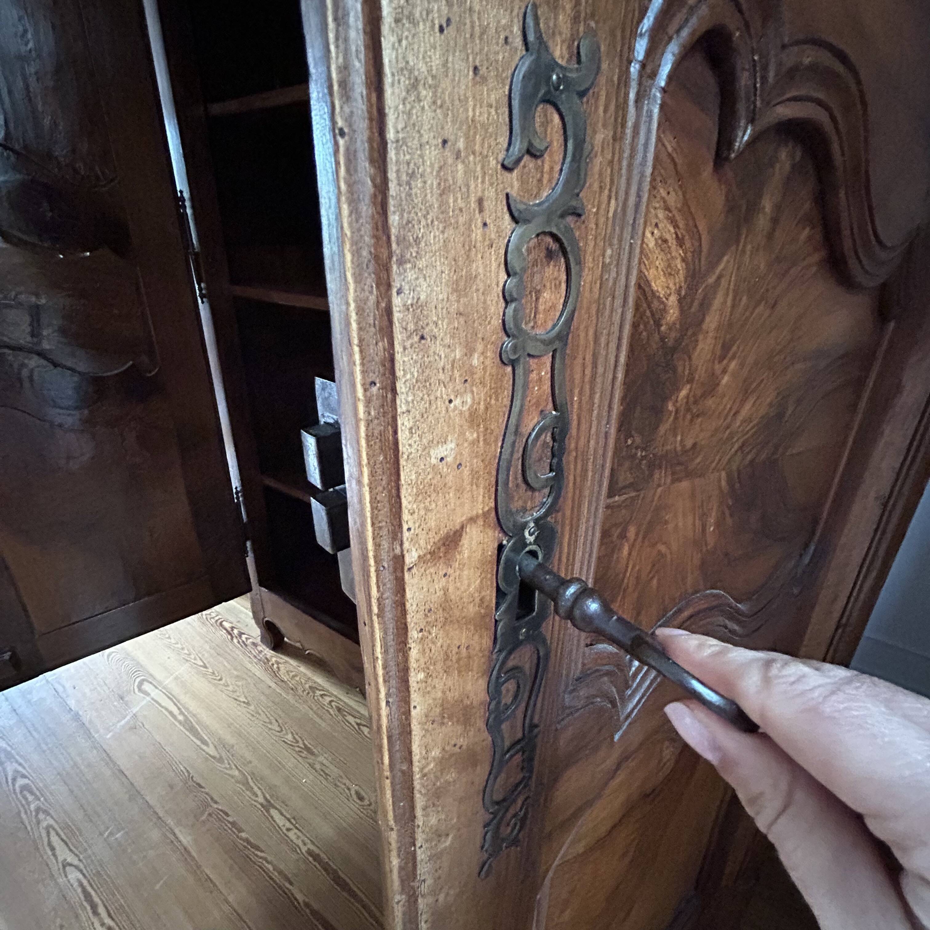 Antique walnut armoire with two doors.