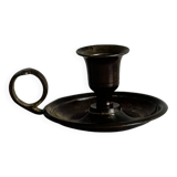 Small antique candle holder in patinated metal