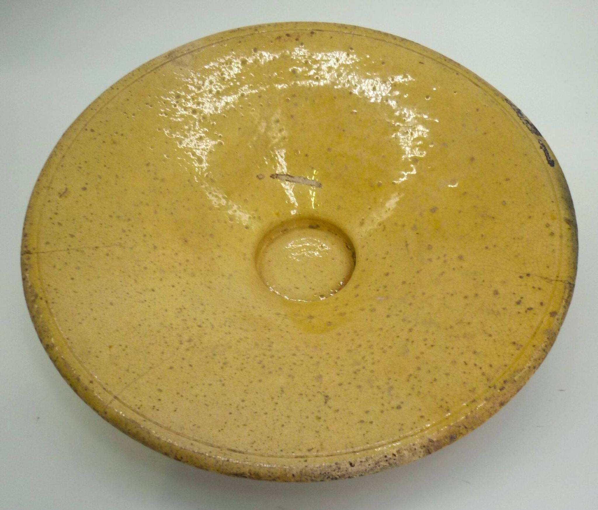 Old omelette turner, glazed yellow terracotta, south of France.