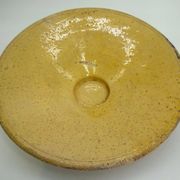 Old omelette turner, glazed yellow terracotta, south of France.