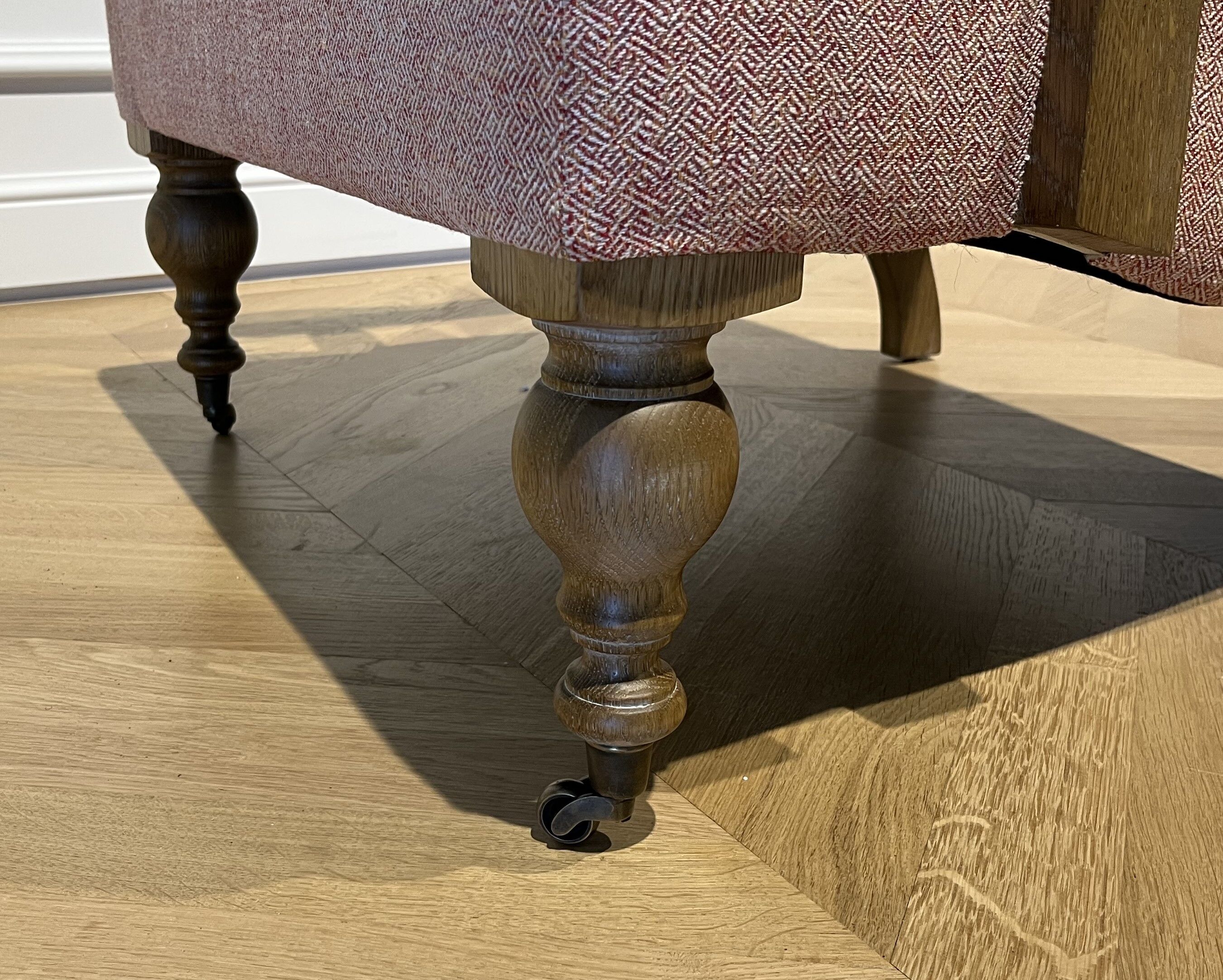 Wooden and red chevron fabric armchair with casters