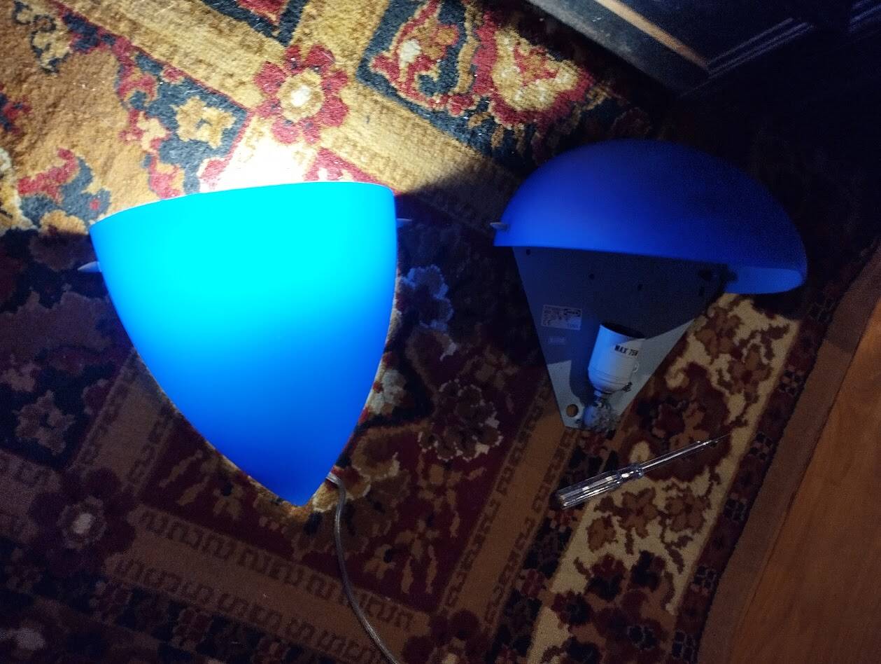 a pair of Ikea Kvintett wall lamps