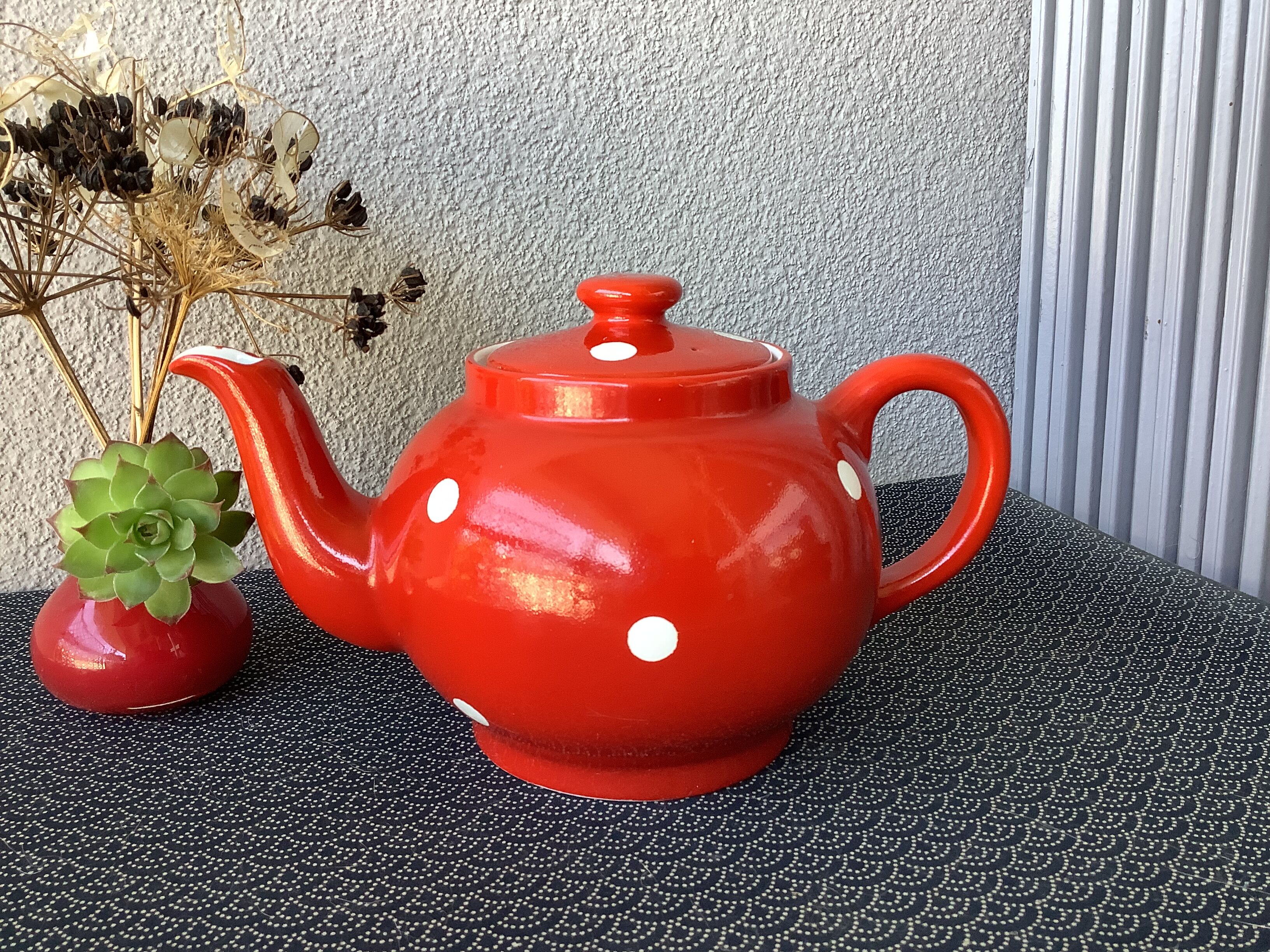 Vintage red teapot with white polka dots