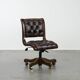 Chesterfield office chair in English style made of cow leather and wood.