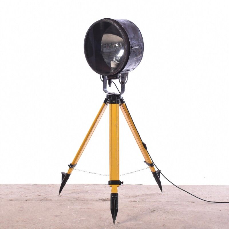 Old industrial spot on wooden tripod