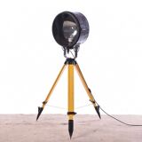 Old industrial spot on wooden tripod