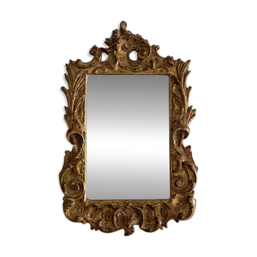 Small antique mirror with carved gilded wood in rococo style.