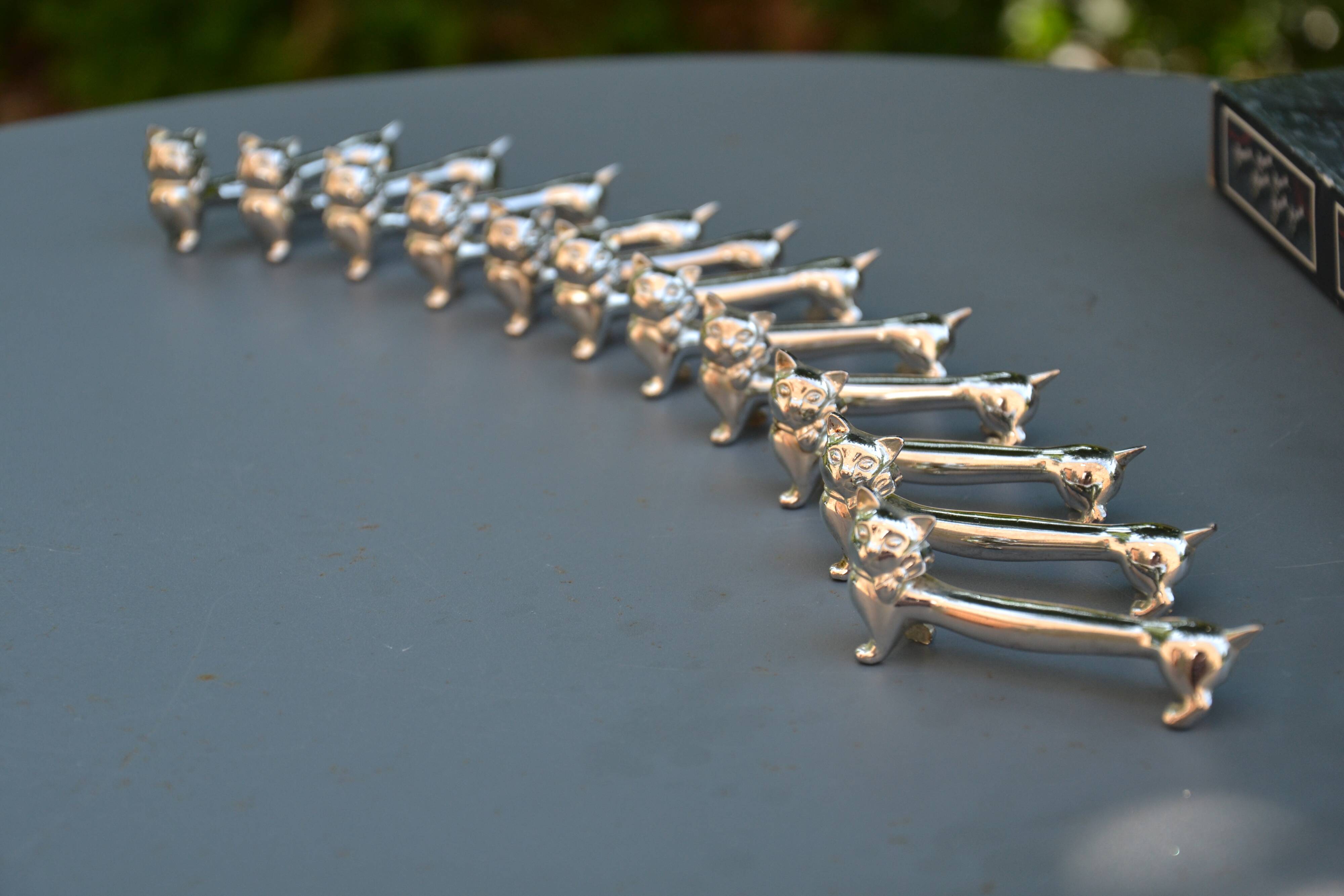 12 silver-plated cat knife rests