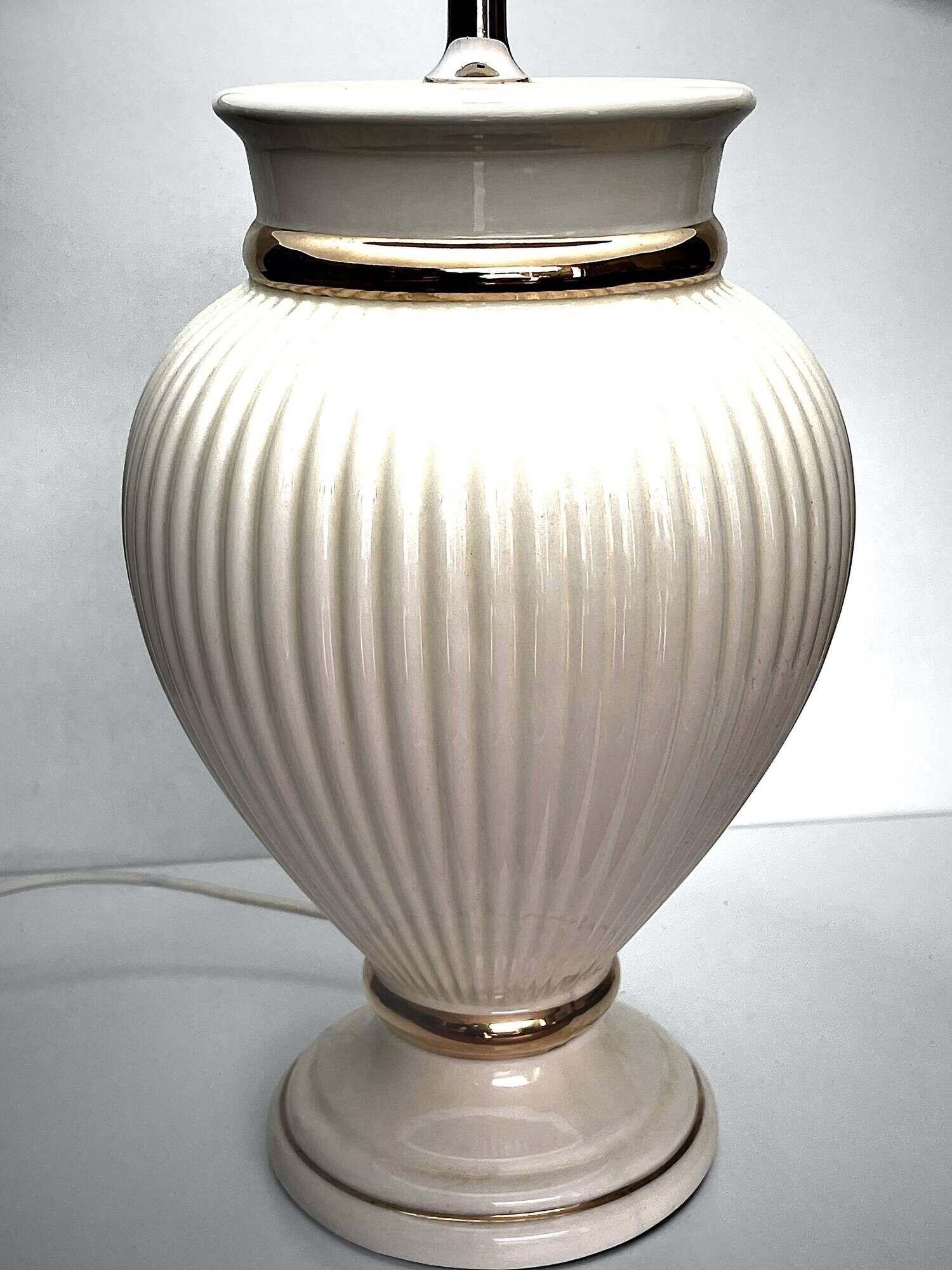 Vintage white ceramic table lamp, ribbed body and conical shade.