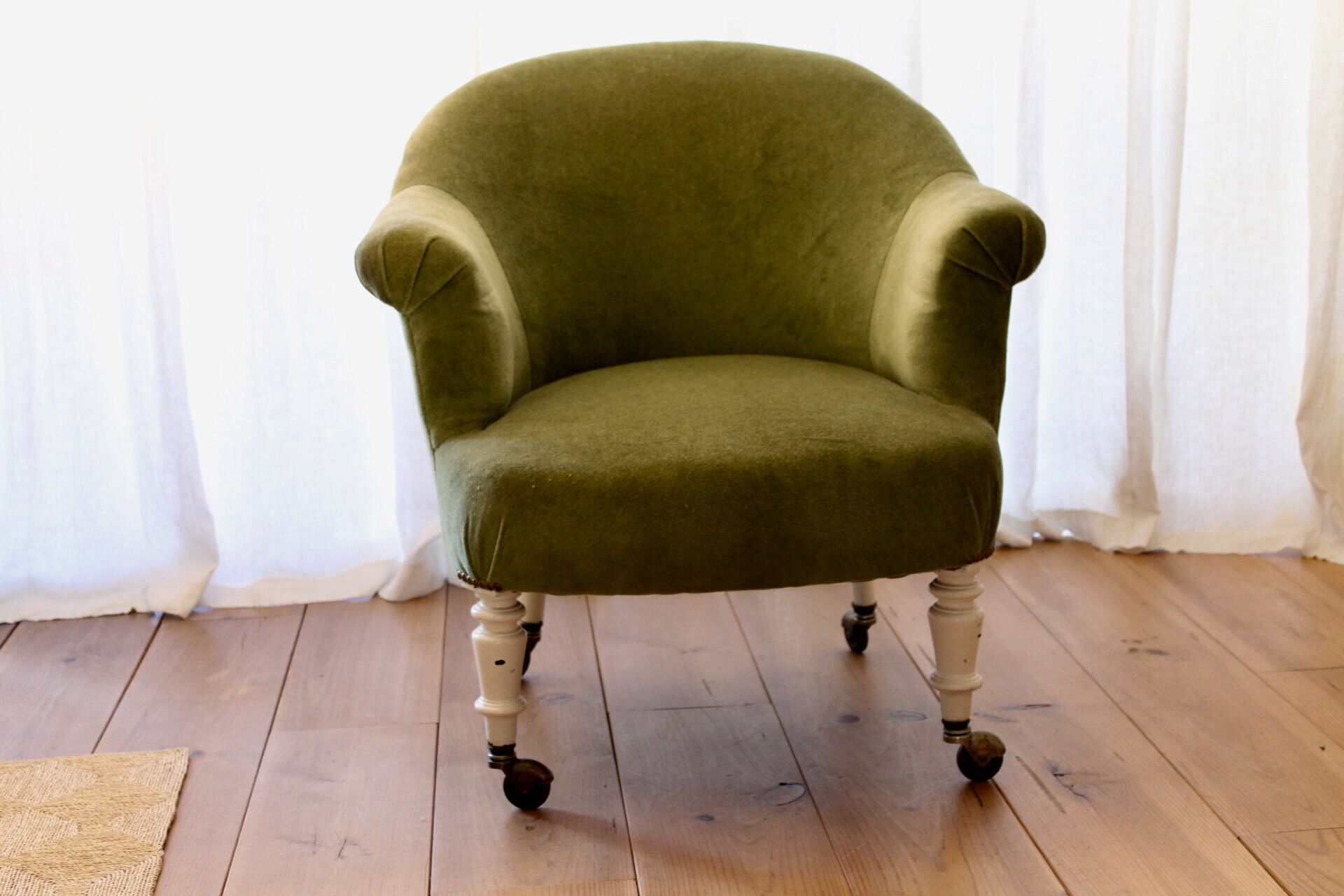 Toad in almond green velvet armchair on castors