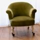 Toad in almond green velvet armchair on castors