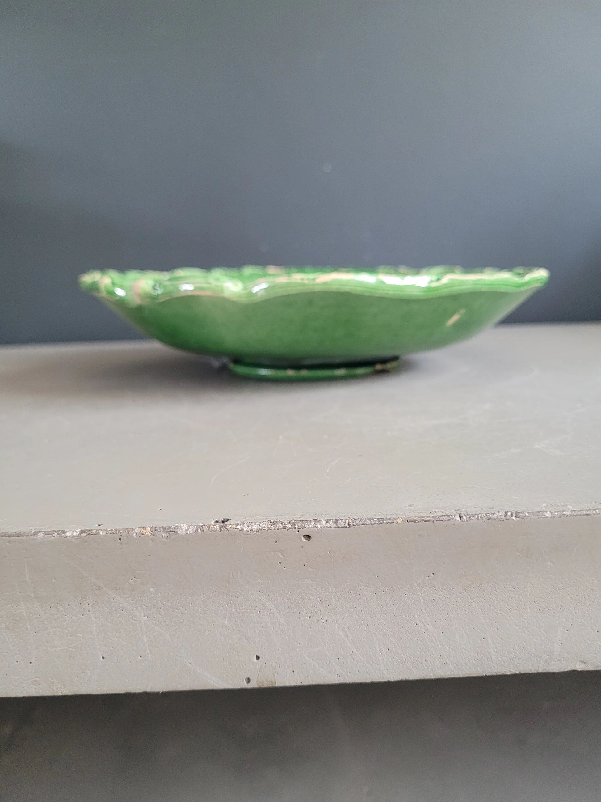 Plate decorated with a sunflower motif in slipware.