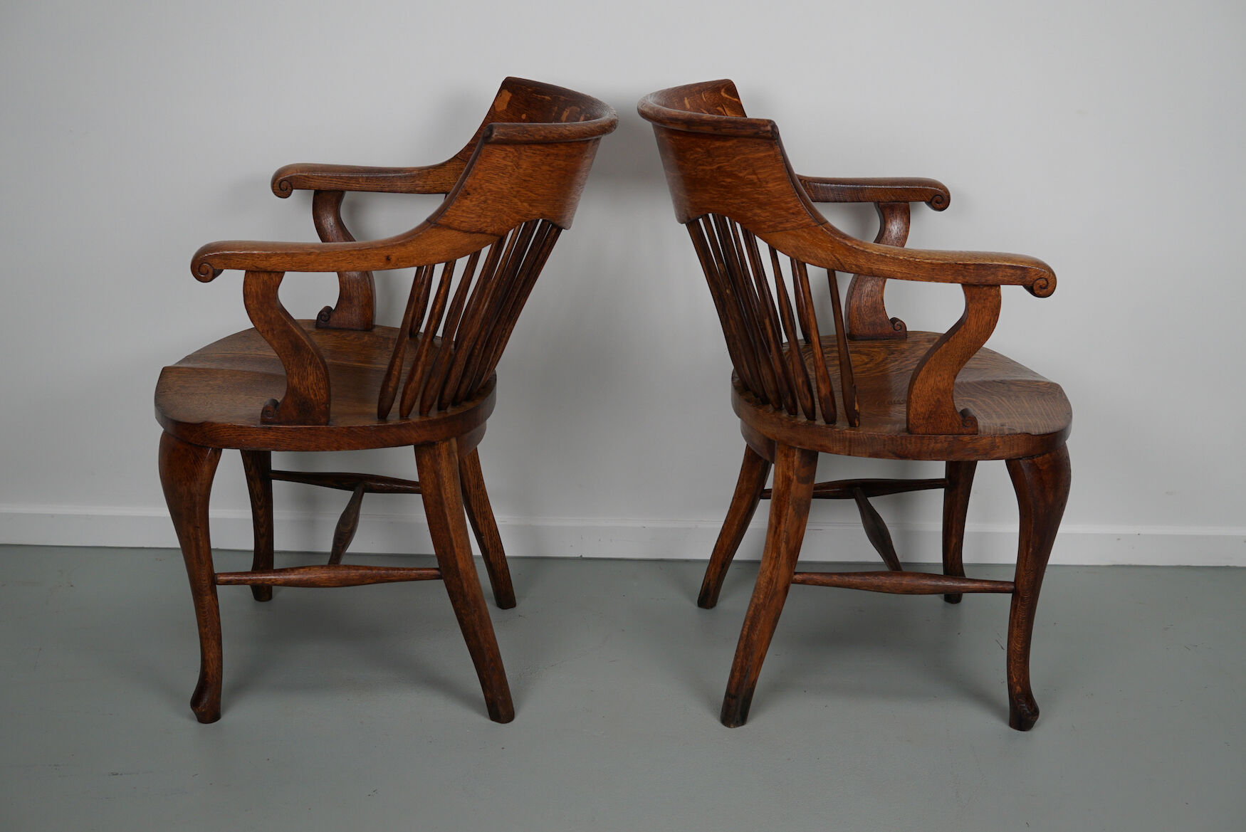 Pair of English Edwardian Oak Spindle Back Captains Office Desk Chairs