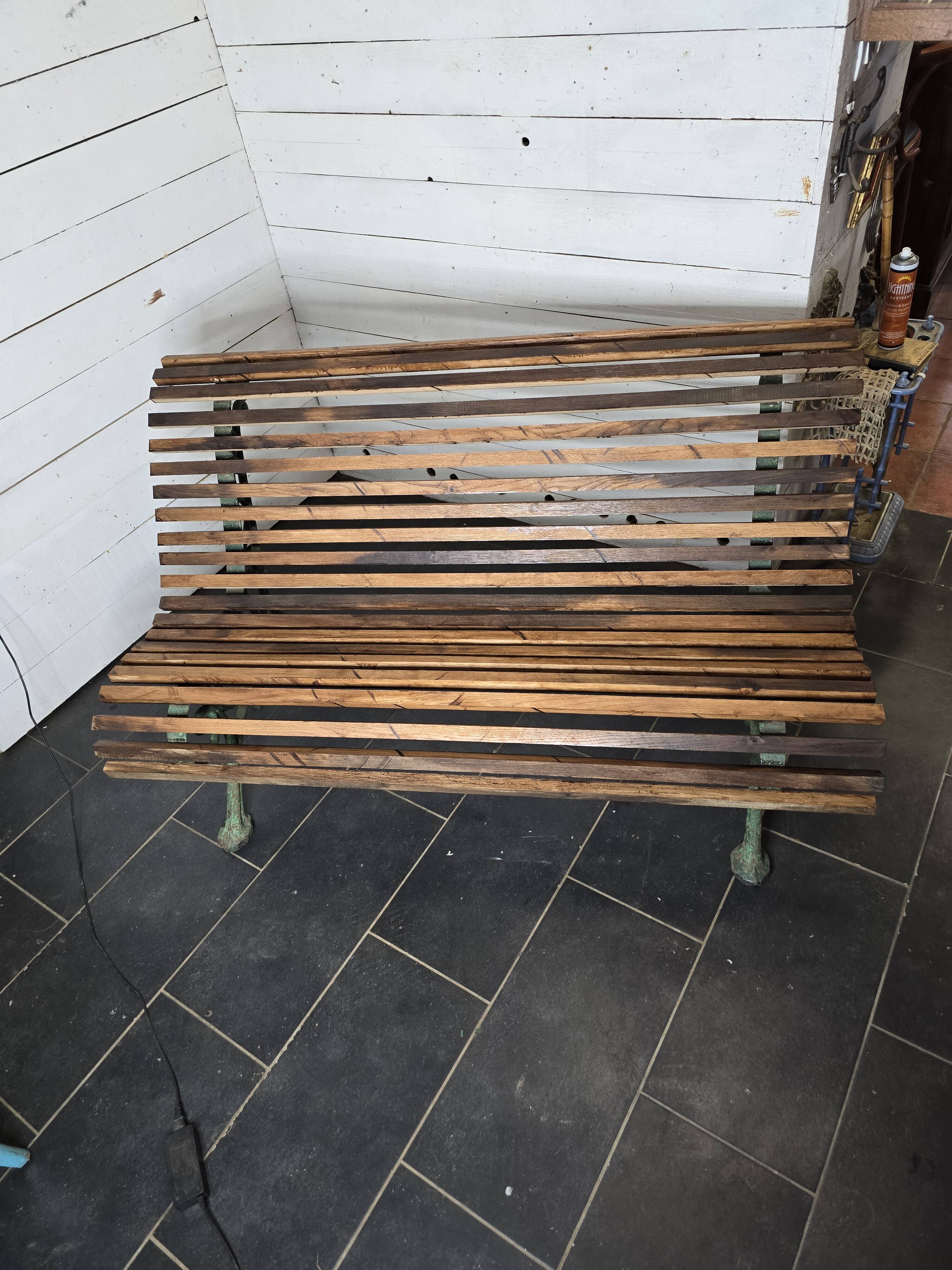 Old cast iron garden bench with oak slats
