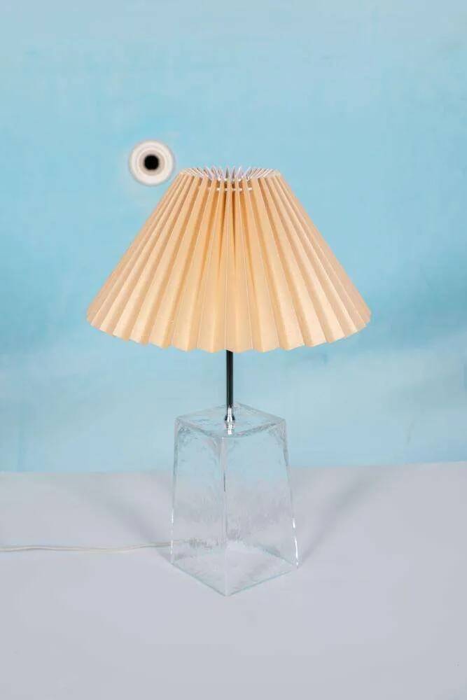 Minimalist glass table lamp from the 80s with a pleated shade.